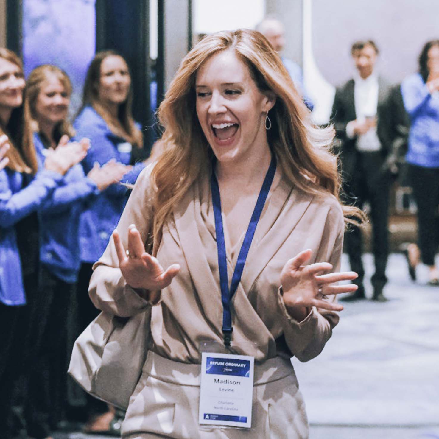 Woman walking through a clap line smiling.