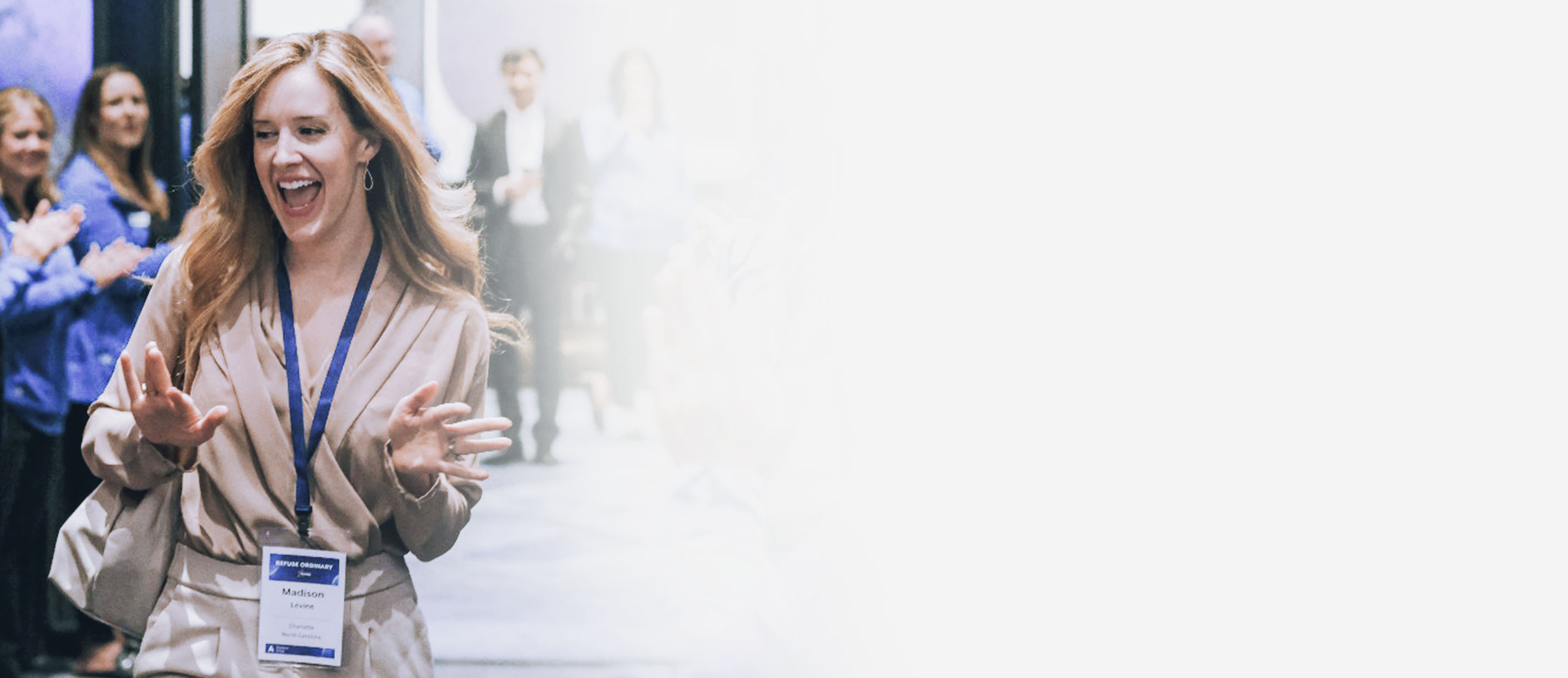 Woman walking through a clap line smiling.